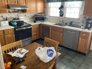 a kitchen with a table with a grocery bag on it at Beach Block Victorian 1 minute from beach in Ventnor City