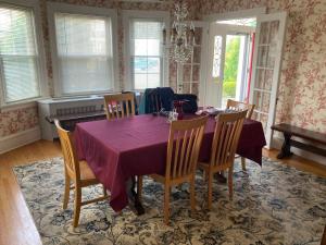 a dining room with a purple table and chairs at Beach Block Victorian 1 minute from beach in Ventnor City