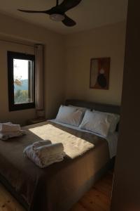 a bedroom with a bed with two towels on it at Villa Milea in Milies Pelion in Mileai
