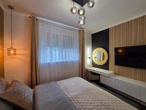 a bedroom with a bed and a sink and a mirror at Guesthouse EL in Ogulin