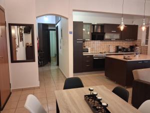 a kitchen and living room with a table and chairs at TAKIS HOUSE in Káto Panayía