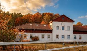 a large white building with a red roof at Herrenhaus Gut Buchenhof in Römhild