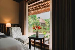 a bedroom with a bed and a room with a window at Tràng An Valley Garden in Ninh Binh