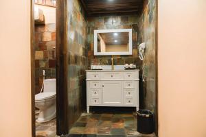 a bathroom with a sink and a toilet and a mirror at Tràng An Valley Garden in Ninh Binh +47 photos