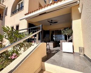 a house with a staircase leading to a patio at Olive Apartment in Tala