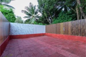 a backyard with a wooden fence and a brick patio at Hotel Suites Inn in Mumbai +20 photos