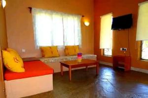 a living room with a couch and a table at Diani cozy cottage camp in Diani Beach