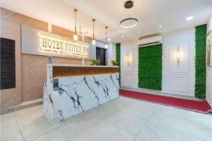 a lobby of a hotel with a sign that reads honey suites inn at Hotel Suites Inn in Mumbai