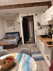 a kitchen and living room with a bed and a table at Apartma Romeo in Piran