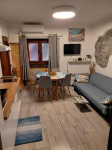 a living room with a couch and a table at Apartma Romeo in Piran