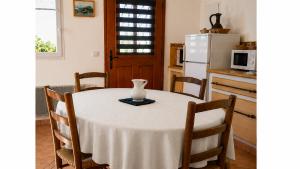 a kitchen with a table with a white vase on it at Gîte Valensole in Valensole