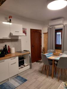 a kitchen and dining room with a table and chairs at Apartma Romeo in Piran +6 photos
