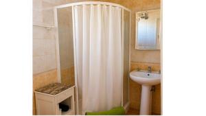 a bathroom with a shower curtain and a sink at Gîte Valensole in Valensole