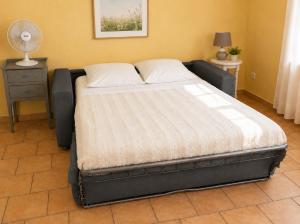 a large bed in a room with a bed frame at Gîte Valensole in Valensole +9 photos