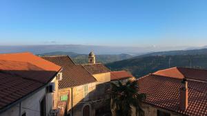 a view of roofs of buildings with mountains in the background at Antica Residenza in Perdifumo
