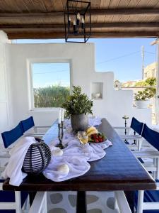 a dining room table with a plate of food on it at Villa ELAYA in Mikonos