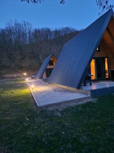 a house with a large pyramid shaped roof at Fikro's Resort in Kulen Vakuf