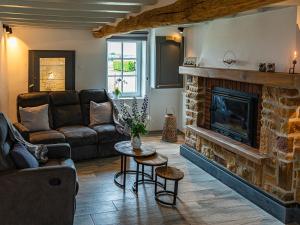 a living room with a couch and a fireplace at La Petite Mazure in Tournai