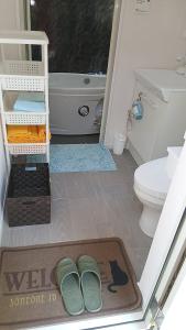 a bathroom with a bath tub and a toilet and a mat at こや・かやき in Yufu +59 photos