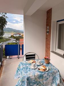 a table with plates of food on top of a balcony at el AS del Puntal in Villaviciosa