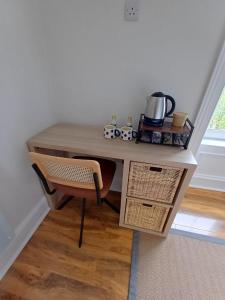 a desk in a room with a table and a chair at Nook and Scranny in Tarbert +16 photos