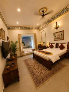 a bedroom with a large bed and a window at Agastya Vilas Resort in Dhandni