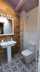 a bathroom with a sink and a toilet and a mirror at Casa Venancio in Trabada +56 photos