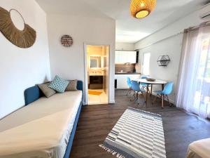 a living room with a couch and a table at Vila Vera Seafront Apartments in Sumartin