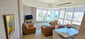 a living room with a couch and a table at Luxury Skyline Apartment with Panoramic Views in Sharjah +3 photos