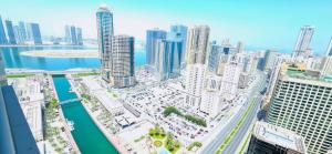 an aerial view of a city with tall buildings at Luxury Skyline Apartment with Panoramic Views in Sharjah