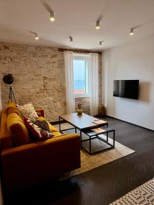 a living room with a couch and a table at Golden View - Old town apartment in Rovinj