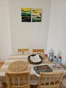 a dining room table with two chairs and a painting at 2 bedroom apartment, near Xbionic in Šamorín