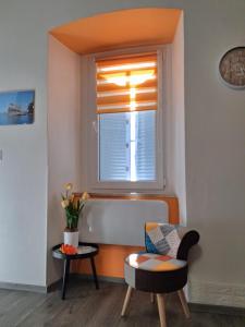 a living room with a window and a chair at La Casetta al Poggio in Valentano