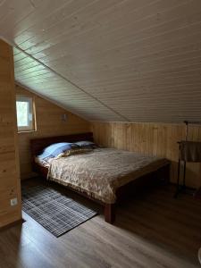 a bedroom with a bed in a wooden cabin at Гостинний двір Підкова in Budishche