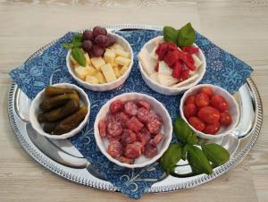 a tray with four bowls of different types of food at Wellness apartmány Puštík se soukromou vířivkou a saunou in Pěnčín