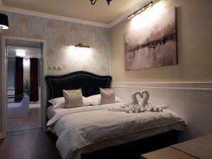 a bedroom with a bed with two swans on it at Wellness apartmány Puštík se soukromou vířivkou a saunou in Pěnčín