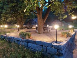 a stone wall with lights in a park at night at Wellness apartmány Puštík se soukromou vířivkou a saunou in Pěnčín +26 photos