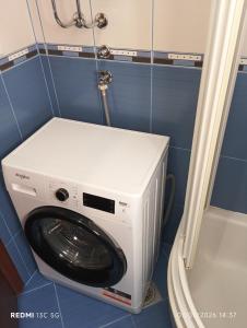 a washer and dryer in a small room at Apartment Grandis in Škaljari