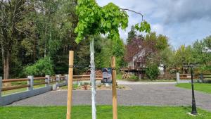 a small tree in front of a fence at Ferienhaus zum Wunschglockerl in Schrems