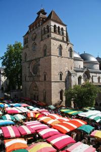 a large group of umbrellas in front of a building at L'Empreinte in Cahors +8 photos