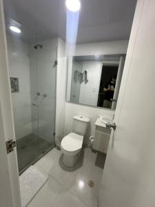 a bathroom with a toilet and a glass shower at Al Reef Apartamentos TOP in San Andrés +202 photos