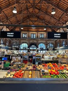 a market filled with lots of different fruits and vegetables at L'Empreinte in Cahors