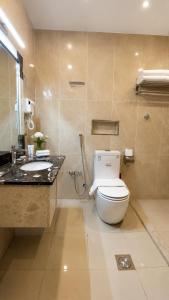 a bathroom with a toilet and a sink at فندق حي الربوه Al Rabwah District Hotel in Tabuk +12 photos