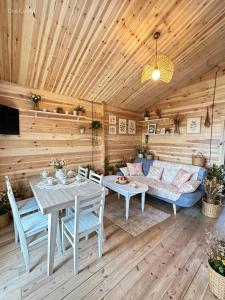 a living room with a couch and a table at chemtan cottages in Dushetʼi