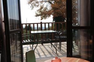 a patio with a table and chairs on a balcony at Villa Milea in Milies Pelion in Mileai