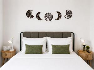 a bedroom with a white bed with green pillows at Pink House - Lisbon in Lisbon