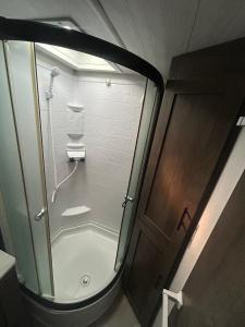 a shower in a bathroom with a glass door at Rocking Horse Stables in Altoona