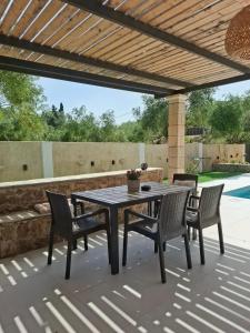 a table and chairs sitting on a patio at Stones villa corfu in Varypatádes