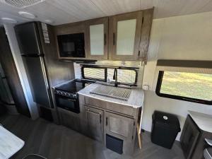 an rv kitchen with a sink and a stove at Rocking Horse Stables in Altoona