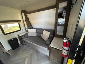 an interior view of an rv with a couch at Rocking Horse Stables in Altoona